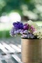 Violet flower in golden can as wedding decoration on sunny day Royalty Free Stock Photo