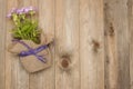 Violet flower Pot with Purple Little Flowers over Rustci wooden Background Flat Lay copy Space Royalty Free Stock Photo