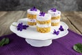 Violet flower small cakes with mascarpone purple cream