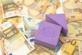 Violet foam toy house on twenty and fifty euro bills Royalty Free Stock Photo