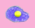 Violet fried egg on pink paper background. Trendy minimal pop art style. Concept colorful food.