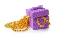 Violet gift box and golden beads Royalty Free Stock Photo