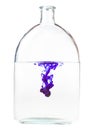 Violet ink dissolves in water in flask isolated Royalty Free Stock Photo