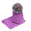 Violet knitted woolen scarf and hat with pompom isolated on white background. Royalty Free Stock Photo