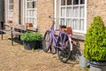 Violet ladies bike against a brick wall Royalty Free Stock Photo