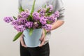 Violet and lilac hyacinths. Spring flowers in vase in woman hand. bulbous plant. Horizontal photo Royalty Free Stock Photo