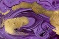 Violet mixed paint abstract background. Purple and gold marble pattern. Royalty Free Stock Photo