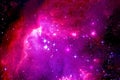 Violet nebula, with bright beautiful stars and dark areas. Elements of this image were furnished by NASA Royalty Free Stock Photo