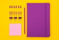 Violet notebook, pencil, clips, clamps, note and others stationary. School accessories or office supplies flat lay Royalty Free Stock Photo