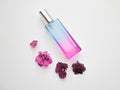 Violet perfume bottle with flowers around. lavender and spring flower aroma, aromatherapy, spa concept, skin care Royalty Free Stock Photo