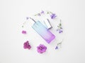 Violet perfume bottle with flowers around. lavender and spring flower aroma, aromatherapy, spa concept, skin care Royalty Free Stock Photo