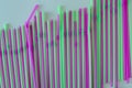 Violet, pink and green drinking straws in rows