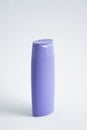 Violet plastic bottle of body care and beauty products. Studio photography of plastic bottle for shampoo, shower gel Royalty Free Stock Photo