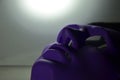 Violet plastic mask of man in the light