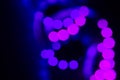 Violet purple neon bokeh lights spiral on black. Abstract background for your design Royalty Free Stock Photo