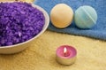 Violet salt with candle and bath balls Royalty Free Stock Photo