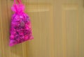 violet Scented bag haging on wood door. Royalty Free Stock Photo