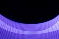 Violet shining neon smooth stripes of light on black background. Abstract background with energy line