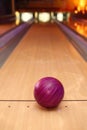 Violet sphere ball standing on long bowling lane Royalty Free Stock Photo