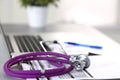 Violet stethoscope on a laptop computer