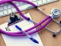 Violet stethoscope on a laptop computer