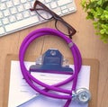 Violet stethoscope on a laptop computer