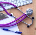 Violet stethoscope on a laptop computer