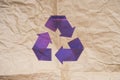 Violet Stylish Recycle Arrow on Craft Paper Background. Reuse Sign. Eco Friendly and Environment Care Concept