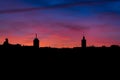 Violet sunset above moroccan city Fes with silhouette of minarets