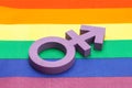 Violet transgender symbol on the background of the rainbow flag of the LGBT pride