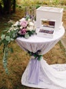 Violet wedding concept. Wedding rings with elegant purple floral decorations at the garden