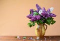 Violet and white lilacs in a vase of ceramics