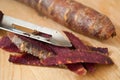 Violets carrots and peelings on wooden cutting board