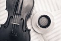 Violin acoustic classical instrument and white coffee cup on sheet for musical notes