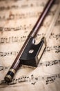 Violin bow on musical sheets Royalty Free Stock Photo
