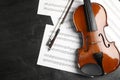 Violin, bow and note sheets on stone table Royalty Free Stock Photo