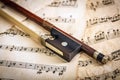 Violin bow on musical sheets Royalty Free Stock Photo