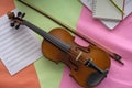 Violin and bow put on colorful background