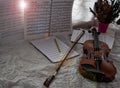 Violin and bow put at the right side of background,beside blank note sheet and book,prepare for practice,blurry light around Royalty Free Stock Photo