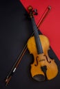 Violin and bow on a red and black background Royalty Free Stock Photo