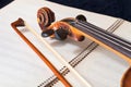 Violin bow and scroll on music book Royalty Free Stock Photo