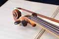 Violin bow and scroll on music book Royalty Free Stock Photo