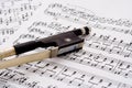 Violin bow on sheet music Royalty Free Stock Photo