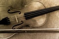 The violin and bow on wooden background toned sepia