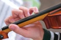 Violin in boy`s hands. Boy is learning to play violin. Correct setting of the fingers of the left hand on the strings of Royalty Free Stock Photo