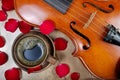 Violin and a cup of coffee. Coffee and rose petals. close up. top view Royalty Free Stock Photo