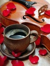 Violin and a cup of coffee. Coffee and rose petals. Top view. close up.