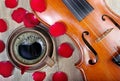 Violin and a cup of coffee. Coffee and rose petals. Top view. close up. Royalty Free Stock Photo