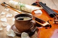 Violin and a cup of coffee. Coffee and rose petals. Royalty Free Stock Photo