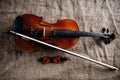 Violin, fiddlestick and bowtie, canvas background Royalty Free Stock Photo